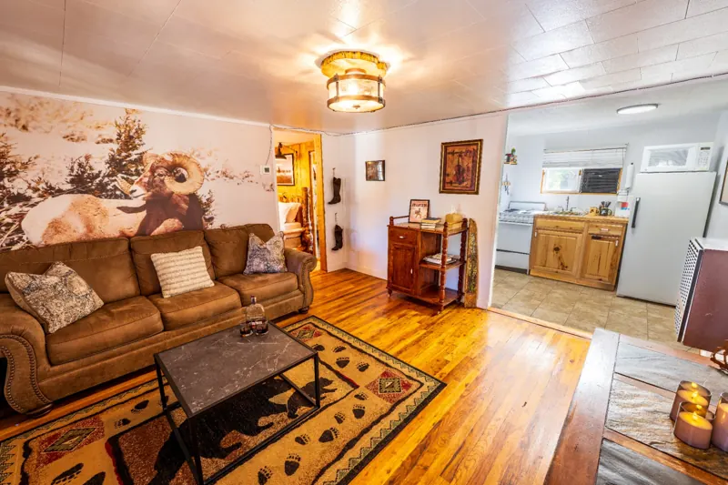 Cassidy Suite two bedroom cabin at The Amoretti Hotel in Dubois, Wyoming, the living area opening into the full kitchen.